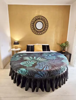 a bedroom with a large bed with a colorful blanket at Yellow Studio in Rome