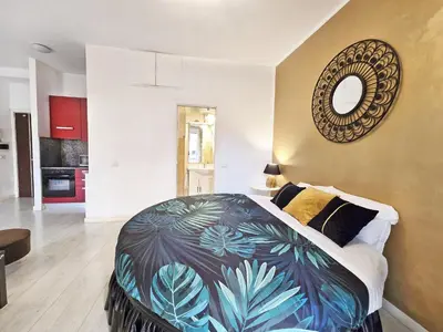 a bedroom with a bed and a mirror on the wall at Yellow Studio in Rome