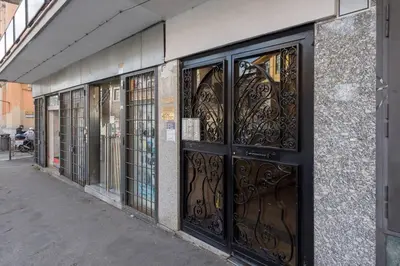 a row of wrought iron doors on a building at Yellow Studio in Rome