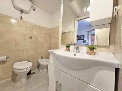 a bathroom with a sink and a toilet and a mirror at Yellow Studio in Rome