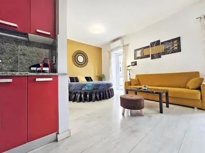 a kitchen and living room with a couch and a table at Yellow Studio in Rome