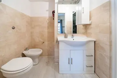 a bathroom with a white toilet and a sink at Yellow Studio in Rome