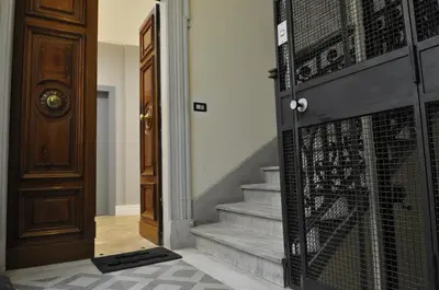a hallway with a door and stairs with a gate at Place 24 Suites & Wellness in Rome