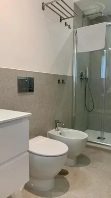 a bathroom with a toilet and a sink and a shower at Room A in Rome