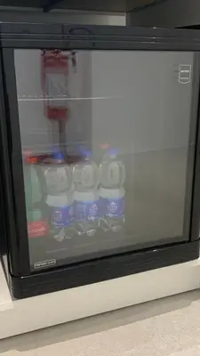 a microwave with bottles of water inside of it at Room A in Rome