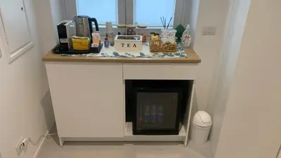 a kitchen with a counter with a fireplace in it at Room A in Rome
