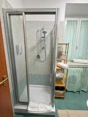 a shower with a glass door in a bathroom at Milena's Home Rome Center in Rome