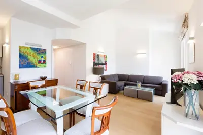 a living room with a glass table and chairs at Roma City Suite with Parking - Villa Borghese in Rome