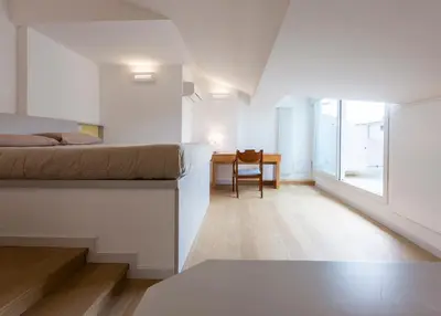 a bedroom with a bed and a desk and a chair at Roma City Suite with Parking - Villa Borghese in Rome