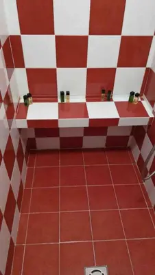 a bathroom with a red and white checkered wall at Roma City Suite with Parking - Villa Borghese in Rome