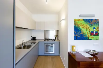 a kitchen with a sink and a stove top oven at Roma City Suite with Parking - Villa Borghese in Rome
