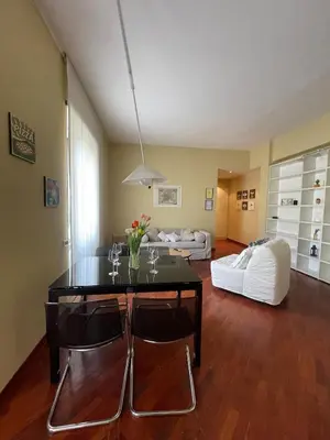 a living room with a table and chairs and a couch at San Giovanni Apartment Rome in Rome