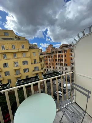 a balcony with a bench and some buildings at San Giovanni Apartment Rome in Rome