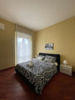 a bedroom with a bed with a zebra print blanket at San Giovanni Apartment Rome in Rome