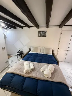 a bedroom with a large bed with towels on it at Rome Nest at Campo De Fiori and Navona Square in Rome