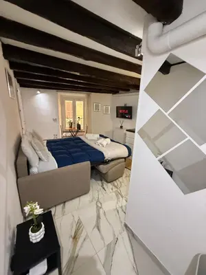 a bedroom with a bed with a blue blanket at Rome Nest at Campo De Fiori and Navona Square in Rome