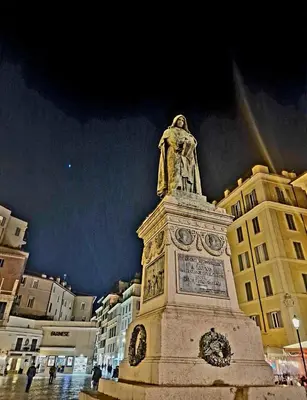 a statue of a man on top of a building at Rome Nest at Campo De Fiori and Navona Square in Rome