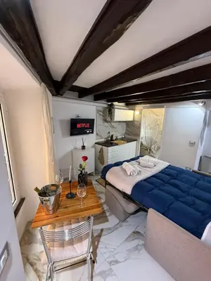 a bedroom with a blue bed and a table at Rome Nest at Campo De Fiori and Navona Square in Rome