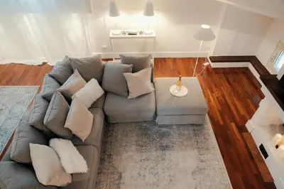 a living room with a gray couch with pillows at Sweet Heaven Apartment in Rome