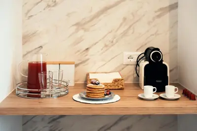 a table with a plate of pancakes and a drink at Sweet Heaven Apartment in Rome