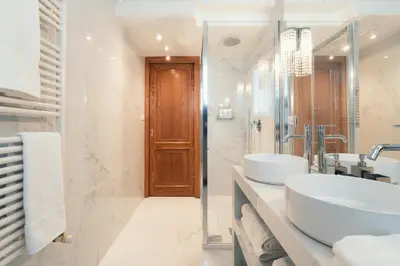 a white bathroom with two sinks and a mirror at Sweet Heaven Apartment in Rome