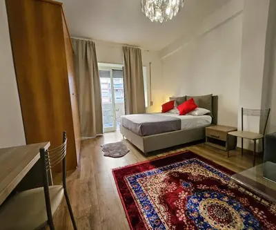 a bedroom with a bed and a rug at Simone House in Rome
