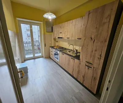 a kitchen with wooden cabinets and a sink at Simone House in Rome