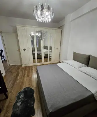 a bedroom with a large bed and a chandelier at Simone House in Rome