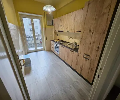 a kitchen with wooden cabinets and a sink and a window at Simone House in Rome