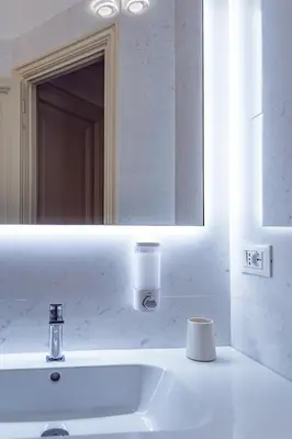 a bathroom with a white sink and a mirror at Lele Rooms Vaticano in Rome