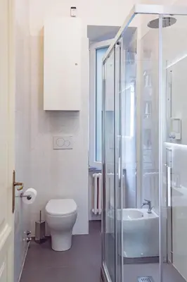 a bathroom with a shower and a toilet and a sink at Lele Rooms Vaticano in Rome