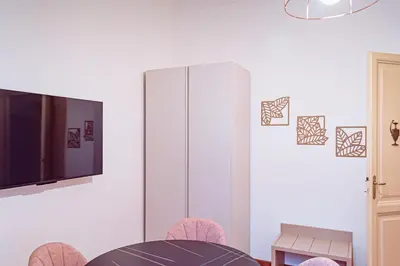 a dining room with a tv and a table and chairs at Lele Rooms Vaticano in Rome