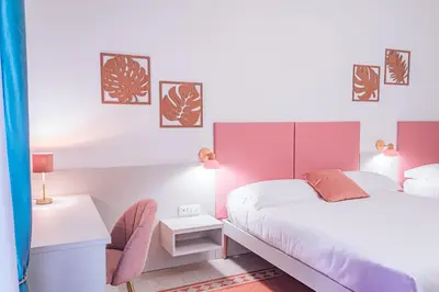 a bedroom with a large bed with a pink headboard at Lele Rooms Vaticano in Rome