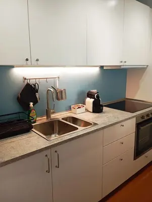 a kitchen with white cabinets and a sink at Panoramic penthouse 10m from metro A in Rome