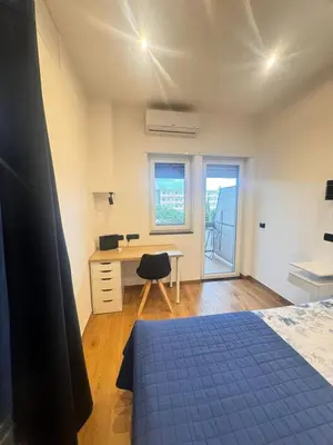 a bedroom with a bed and a desk and a window at Dolce Sosta Vatican Home close to St Peter's in Rome