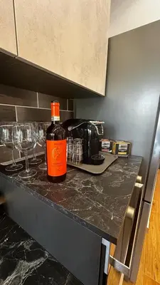 a bottle of wine sitting on a counter in a kitchen at Dolce Sosta Vatican Home close to St Peter's in Rome
