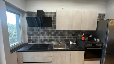 a kitchen with a sink and a black counter top at Dolce Sosta Vatican Home close to St Peter's in Rome