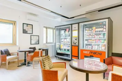 a restaurant with a drink cooler and tables and chairs at Dolce Sosta Vatican Home close to St Peter's in Rome