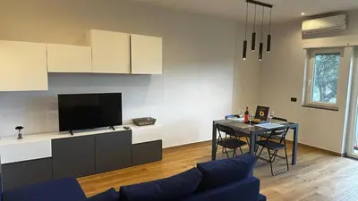 a living room with a couch and a table with a tv at Dolce Sosta Vatican Home close to St Peter's in Rome