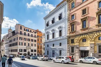 a group of buildings on a city street with cars at Stradivari in Rome