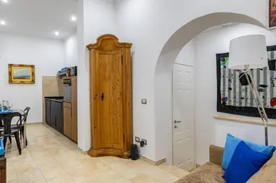 a living room with a couch and a wooden door at Stradivari in Rome