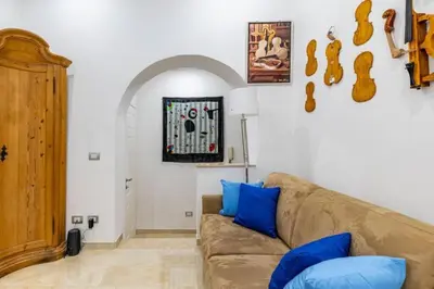 a living room with a brown couch and blue pillows at Stradivari in Rome