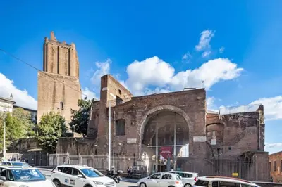 a large brick building with cars parked in front of it at Stradivari in Rome