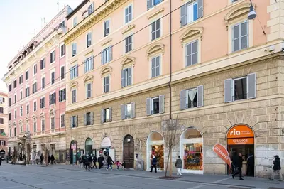 a large building with people walking in front of it at Idyllia - Spacious bright flat in Rome