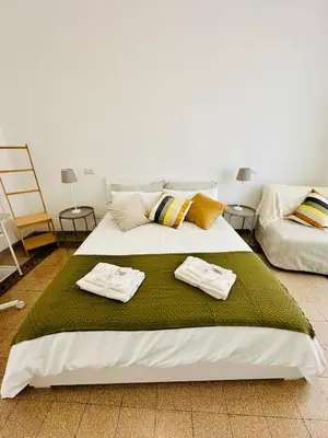 a bedroom with a bed with towels on it at Gattamelata in Rome
