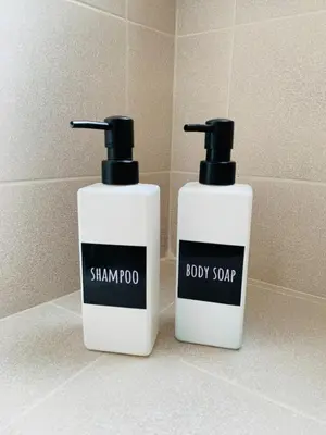 two bottles of shampoo and body soap sitting on a bathroom counter at Gattamelata in Rome