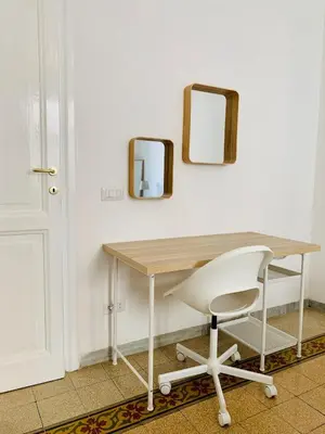 a desk with a chair and a mirror on a wall at Gattamelata in Rome