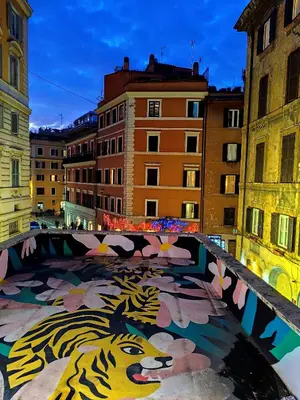 a bridge in a city with a painting of a tiger at COLOSSEUM Studio Flat in Rome