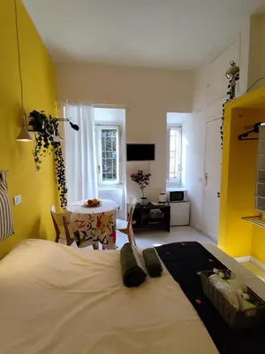 a bedroom with a bed and a table in a room at COLOSSEUM Studio Flat in Rome