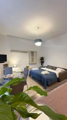 a bedroom with a bed and a couch in a room at Vatican YH in Rome